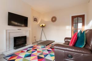 a living room with a couch and a fireplace at 2 Bed Property, sleeps 5, free parking, near city centre in Edinburgh