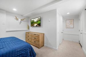 a bedroom with a blue bed and a bird on the wall at Rucker Avenue Cozy Bungalow in Everett