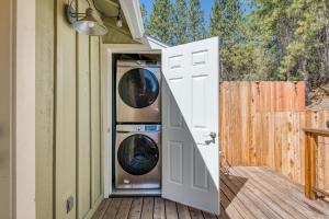 an open door to a house with a washer and dryer at Cottage Like Suite with Private Hot Tub in Bass Lake +4 photos