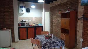 a kitchen with a table with chairs and a counter at Santo Tomás in San Juan