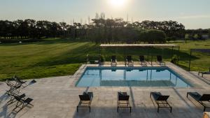 an overhead view of a swimming pool with chairs around it at Finca del Sacramento in Colonia del Sacramento