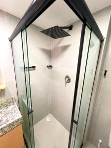 a shower with glass doors in a bathroom at Flatzin Porto de Galinhas Praia e Centrinho in Porto De Galinhas +37 photos
