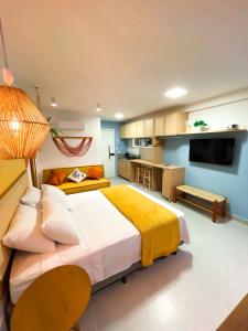 a large bedroom with a large bed and a kitchen at Flatzin Porto de Galinhas Praia e Centrinho in Porto De Galinhas