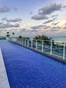 a swimming pool on the roof of a resort at Flatzin Porto de Galinhas Praia e Centrinho in Porto De Galinhas