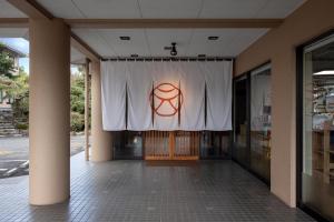 a stage with a white curtain on the side of a building at Ureshino Motoyu in Ureshino