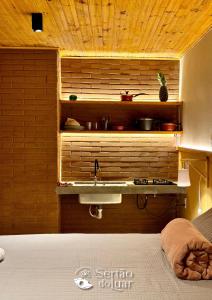 a bathroom with a sink and a counter with a sink at Chalé Caroá in São Raimundo Nonato
