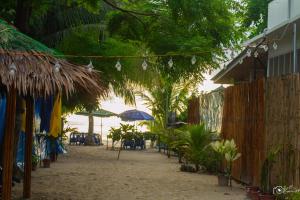 a beach with chairs and umbrellas on the beach at Chef Panyang Beach Resort Okoy in Ocoy