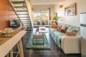 a living room with a couch and a table at Ti Kaz Oreo - Cosy Plage & confort - Wiskeys in Saint-Gilles les Bains