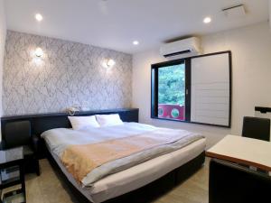 Una cama o camas en una habitación de ホテルスクエア沼津