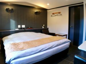 Una cama o camas en una habitación de ホテルスクエア沼津