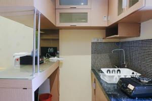a kitchen with a counter and a sink in it at Strategic 2BR Gateway Ahmad Yani Cicadas Apartment By Travelio in Bandung