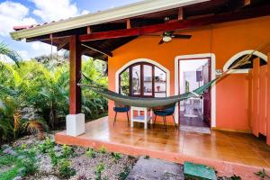a hammock hanging from the side of a house at Couples Tropical Getaway with Pool, Playa Potrero in Potrero