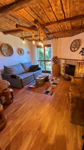 a living room with a couch and a fireplace at Recanto da Serenidade in Campos do Jordão