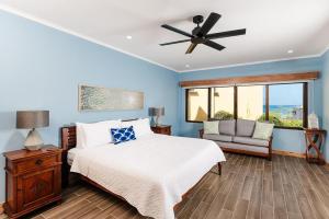 a bedroom with a bed and a ceiling fan at Wake Up to Ocean Views, Pool, Walk to Sandy Beach in Tamarindo