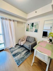 a living room with a couch and a table at The Celandine Balintawak Quezon City in Manila