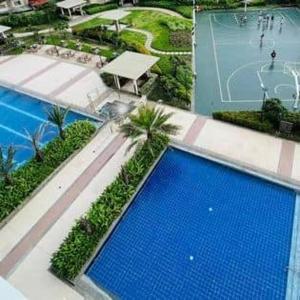 an overhead view of a swimming pool in a resort at The Celandine Balintawak Quezon City in Manila +8 photos