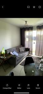 a living room with a couch and a table at Residencial Havaí in João Pessoa +36 photos