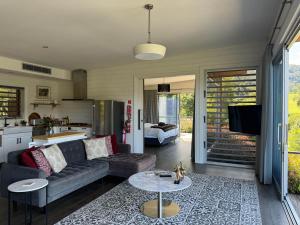 a living room with a couch and a table at Amaroo Valley Springs in Barrengarry