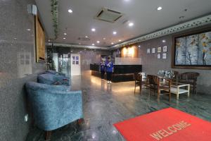 a lobby with two people standing in a room at Hotel Sri Puchong in Puchong