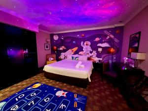 a purple bedroom with a bed with a purple ceiling at Merchant Hotel in George Town