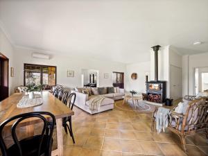 a living room with a table and a couch at Island Brook Estate Vineyard and Chalets in Yelverton