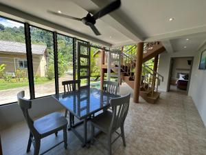 a dining room with a glass table and chairs at Sakoo Valley Naithon Beach in Nai Thon Beach