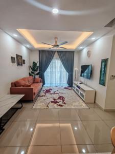 a living room with a couch and a television at Imanie Hstay Southvillecity - Moslim friendly in Kampong Tangkas