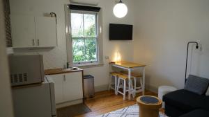 a small kitchen with a sink and a table at Stay on March - Heritage Charm in Orange