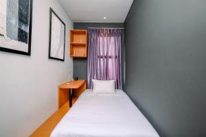 a small room with two beds and a window at Good Deal 2BR at High Floor Transpark Cibubur Apartment By Travelio in Depok +16 photos