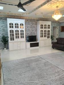 a large living room with a couch and a tv at Homestay Banglo Tengah Pekan in Alor Setar