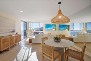 a living room with a table and chairs and a couch at Aquamarine Best View in Malibu by Stay Awhile Villas in Malibu Beach