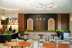 a restaurant with tables and chairs and a bar at Garden Hotel II in Ha Giang