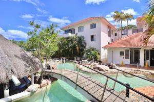 a bridge over a pool at a resort at Chic 2 bdrm Poolside Apartment in Noosa Heads +40 photos