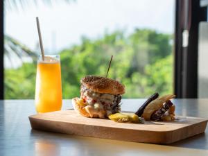 a sandwich and a glass of orange juice on a table at Glamday Style Okinawa Yomitan Hotel & Resort in Yomitan
