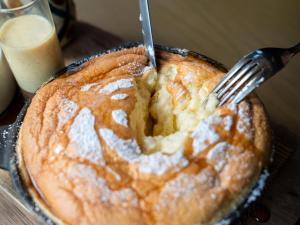 a fork in a cake with powdered sugar at Glamday Style Okinawa Yomitan Hotel & Resort in Yomitan