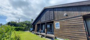 a wooden building with a car parked outside of it at Minpaku Yururi in Yakushima