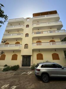 a car parked in front of a building at Morning Star Apartment in Luxor