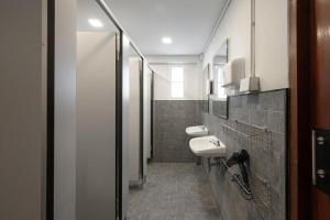 a bathroom with two sinks and two toilets at Ed Hostel Rachamakka in Chiang Mai
