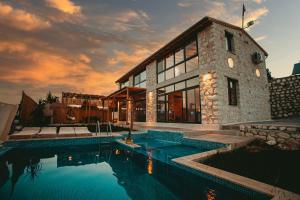 a house with a swimming pool in front of it at villa sunrise in Demre