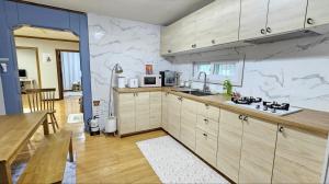 a kitchen with a sink and a microwave at Byulchae Guest House - Foreigner Only in Seoul