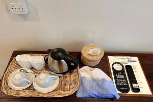 a tray with a tea pot and dishes on a table at Nuan Nil Secret Courtyard in Chiang Mai