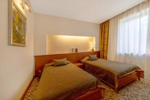 Postel nebo postele na pokoji v ubytování Pažaislis Park Hotel