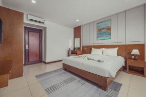 a bedroom with a large bed in a room at Star Hotel and Spa Danang in Danang