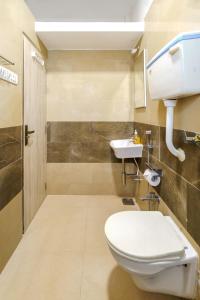 a bathroom with a toilet and a sink at Quirky 1BHK Bandra W by The Bombay Home Company in Mumbai