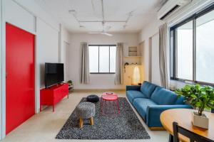 a living room with a blue couch and a table at Quirky 1BHK Bandra W by The Bombay Home Company in Mumbai
