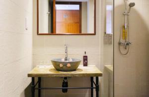 a bathroom with a bowl sink and a shower at Butterfly on Wellington, Central in Hong Kong