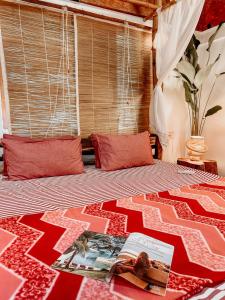 a bedroom with a bed with a book on it at Surangi Homestays in Ajgaon