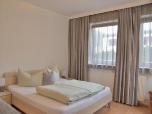 a bedroom with a white bed and a window at Chalet in Fulpmes near Stubai Glacier Skiing in Fulpmes
