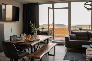 a living room with a wooden table and a couch at Penthouse Brockenblick 381 in Braunlage