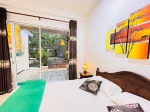 a bedroom with a bed and a large window at Lotus Dreams Crystal in Weligama